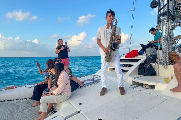 a group of people standing next to a body of water