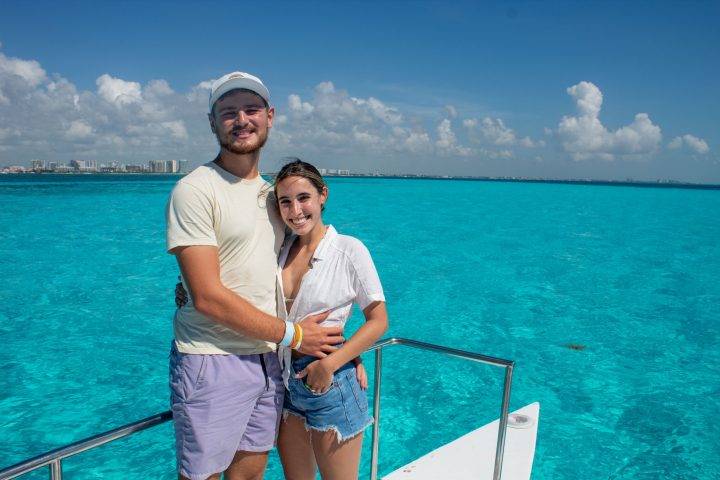 a man standing next to a body of water