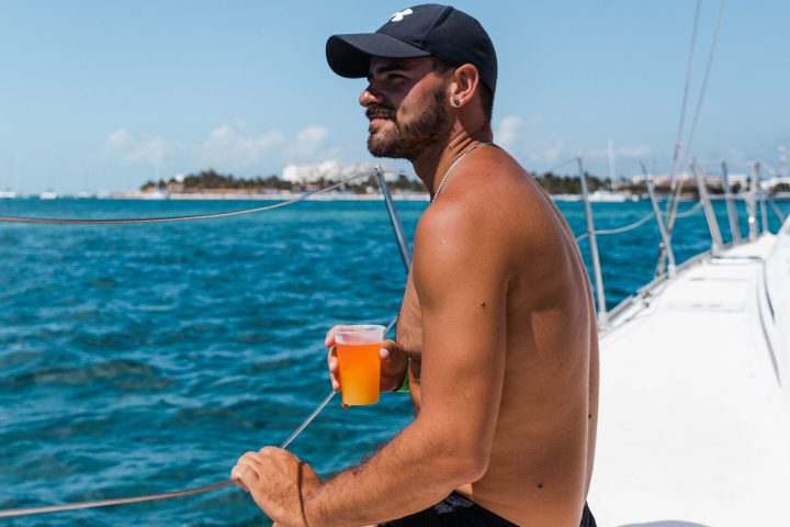 a man standing next to a body of water