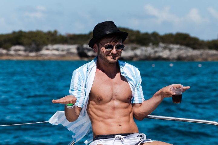 a man standing next to a body of water