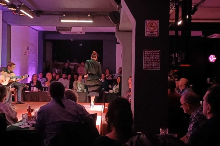 a group of people sitting at a table in front of a crowd
