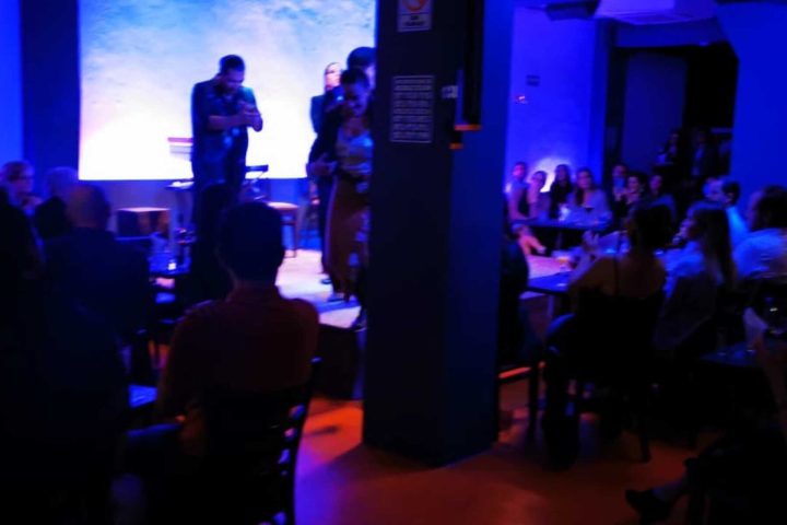 a group of people watching television in a dark room