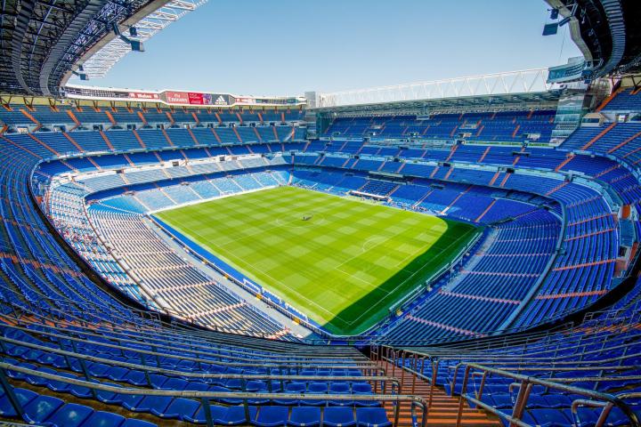 a stadium with people in the background with Santiago Bernabéu Stadium in the background