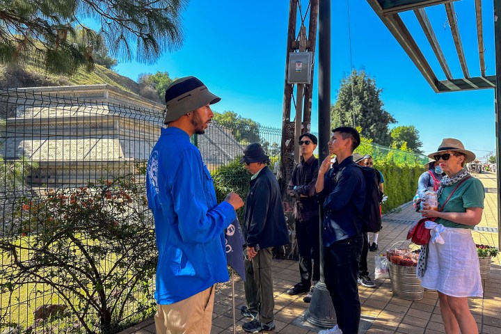 a group of people standing next to a child
