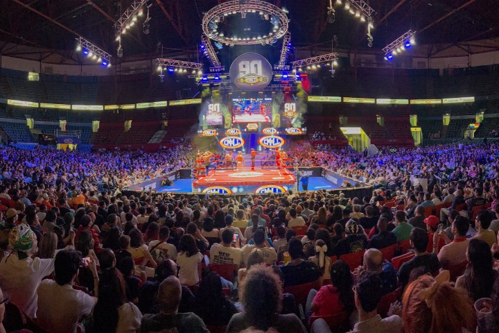 a group of people on a stage in front of a crowd