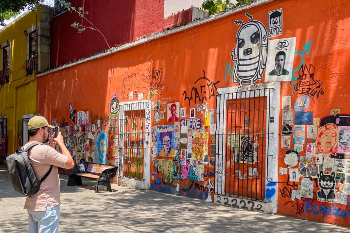 a man with graffiti on the side of a building