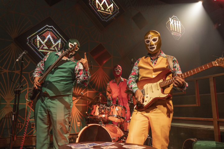 a person holding a guitar on a stage