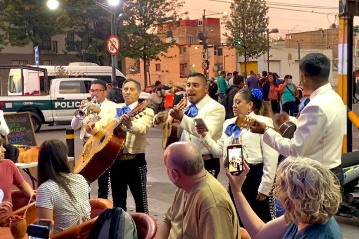 a group of people sitting at a table in front of a crowd