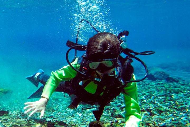 a child swimming in a body of water