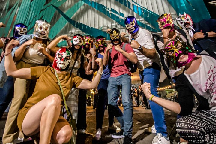 a group of people sitting and standing in front of a crowd