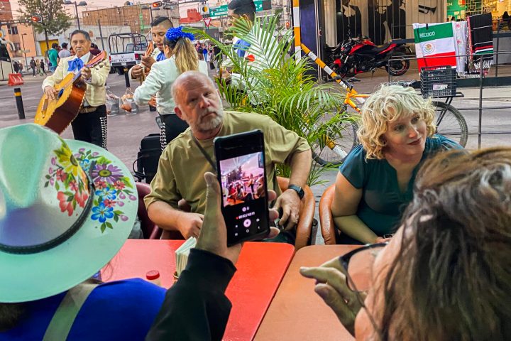 a group of people sitting at a table in front of a crowd