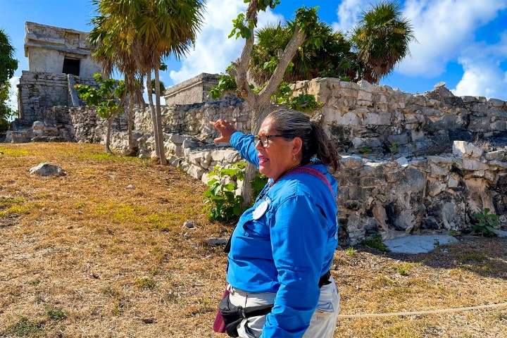 a person standing in front of a rock