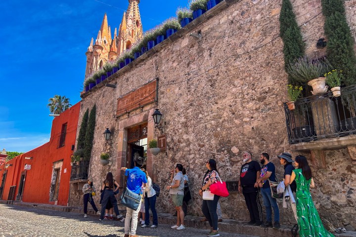 a group of people standing in front of a brick building