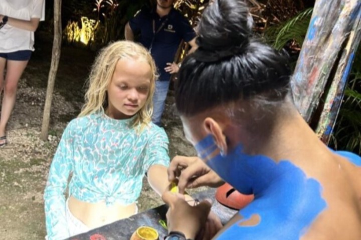 a group of people standing next to a child