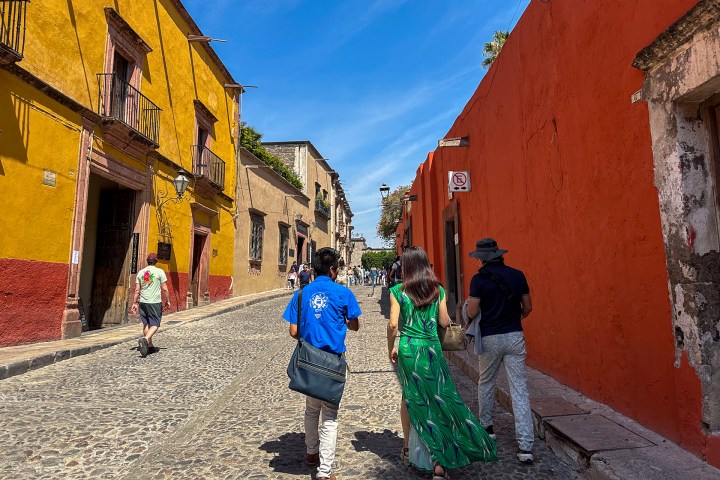 a group of people standing in front of a brick building