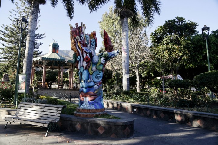 a wooden statue in a park
