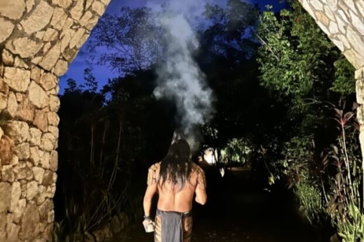 a person standing next to a brick wall