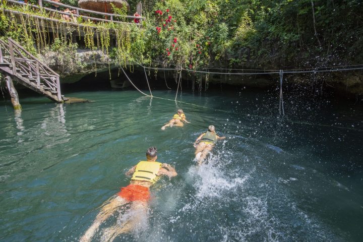 a person riding on the back of a boat in the water