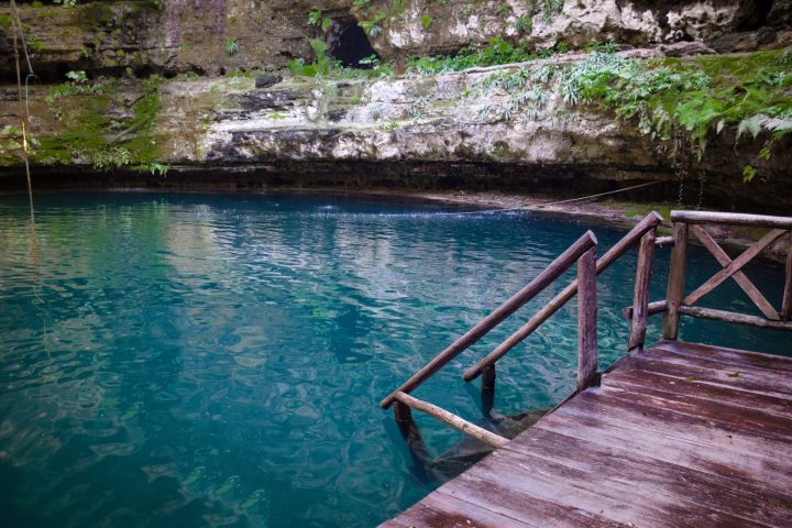 a wooden bench sitting next to a body of water