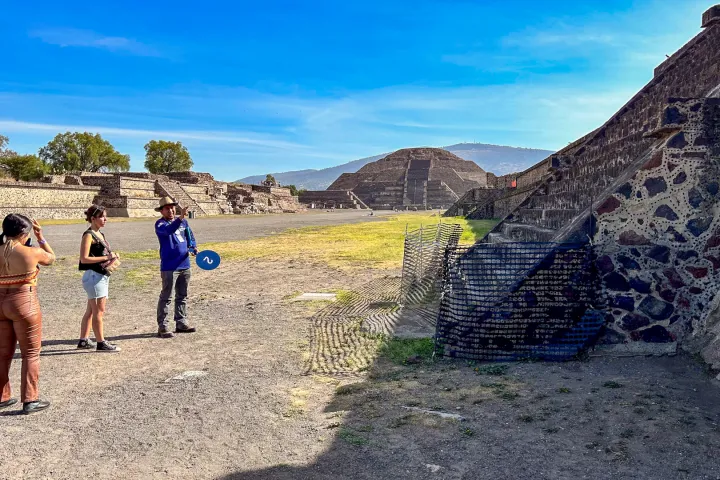 a group of people walking down a dirt road