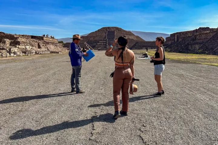 a group of people walking down a dirt road