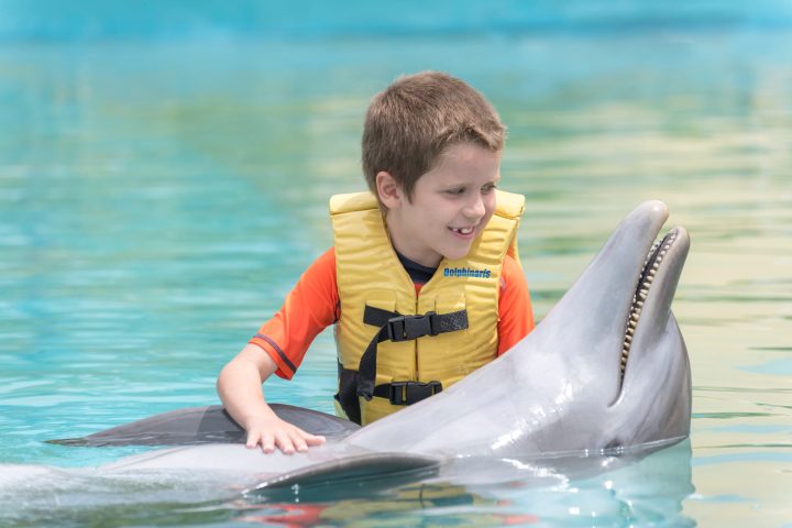 a little boy that is sitting in the water