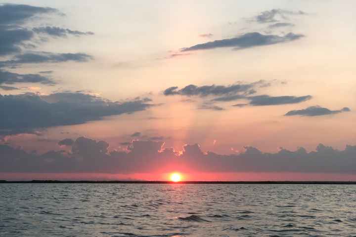 a sunset over a body of water