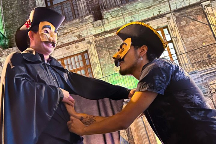 a man standing next to a fence