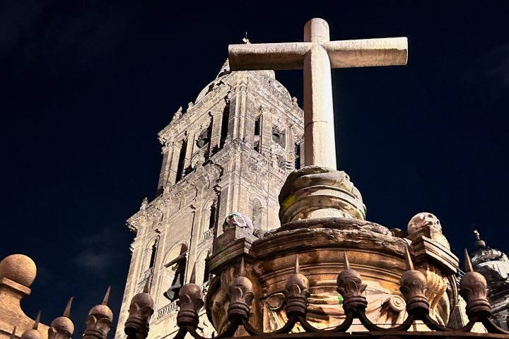 a statue of a person standing in front of a building