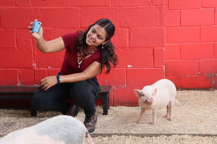a little girl sitting in front of a building