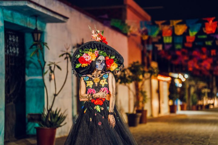 a vase of flowers sits in front of a building