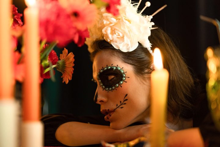 a close up of a woman with pink hair looking at the camera