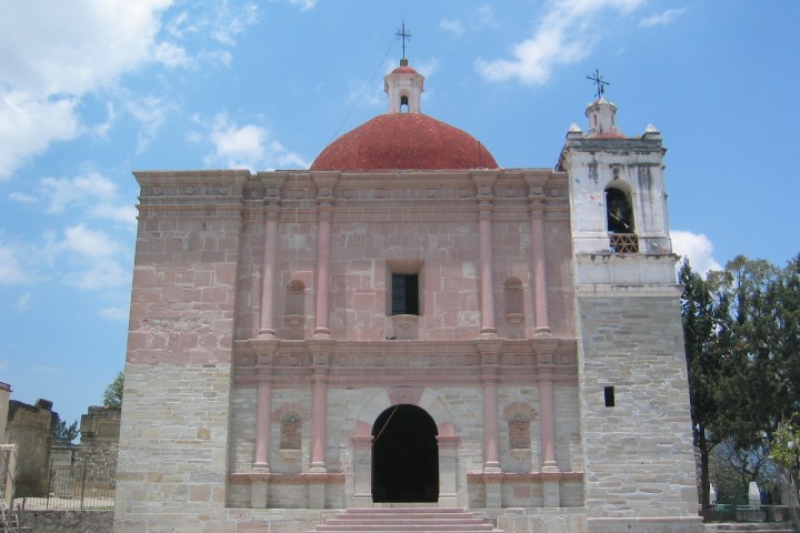 a clock tower in front of a brick building