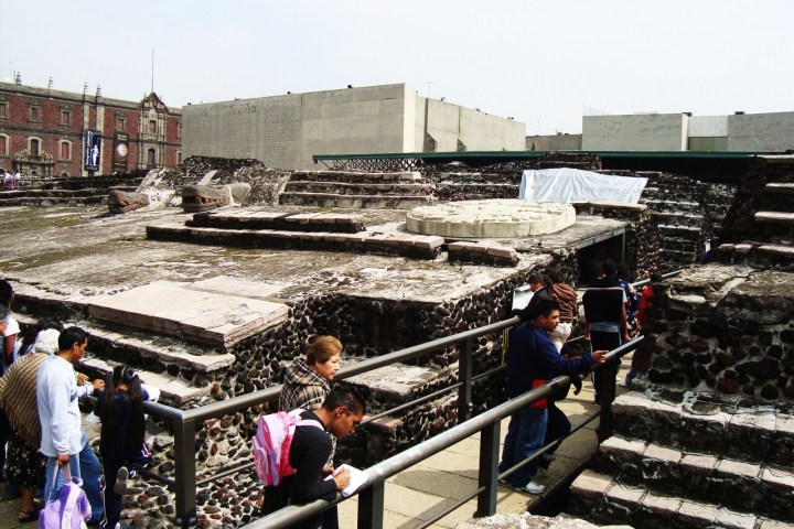 a group of people walking on a bridge