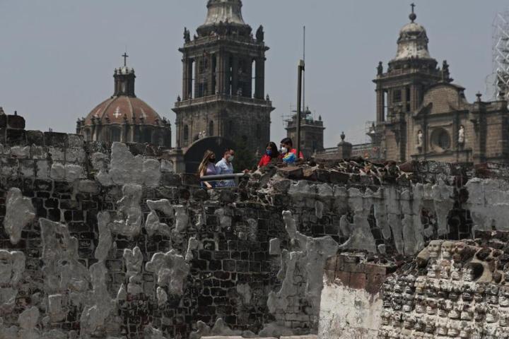 a group of people standing in front of a stone building