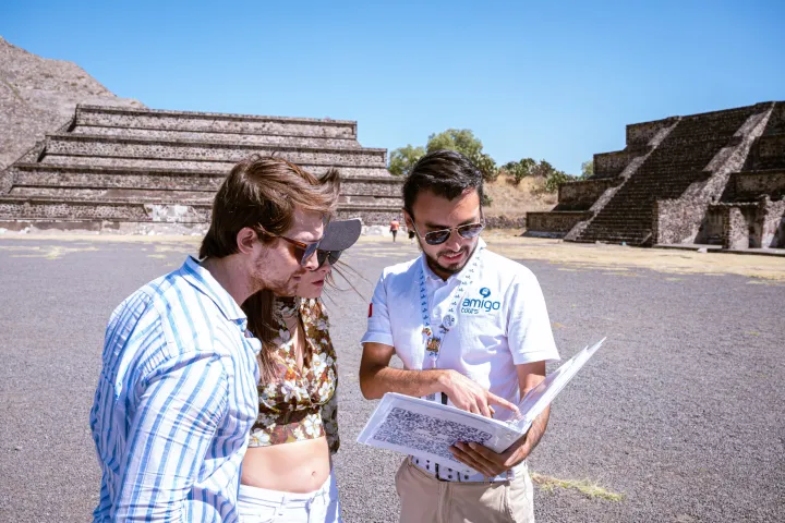 a man and woman sitting next to a building