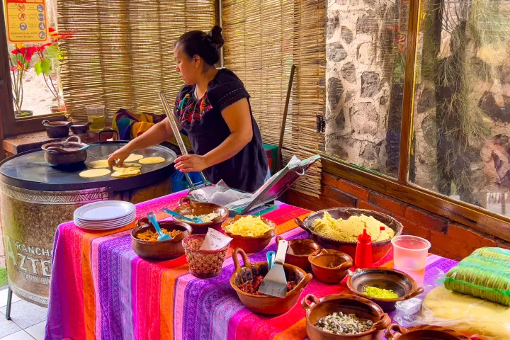 a woman standing in front of a cake