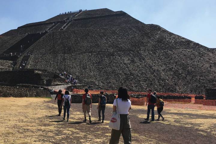a group of people standing on top of a mountain