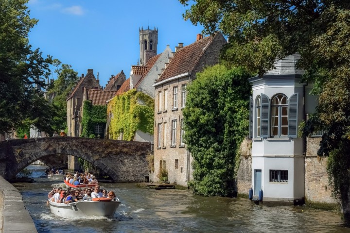 a small boat in a body of water in front of a building