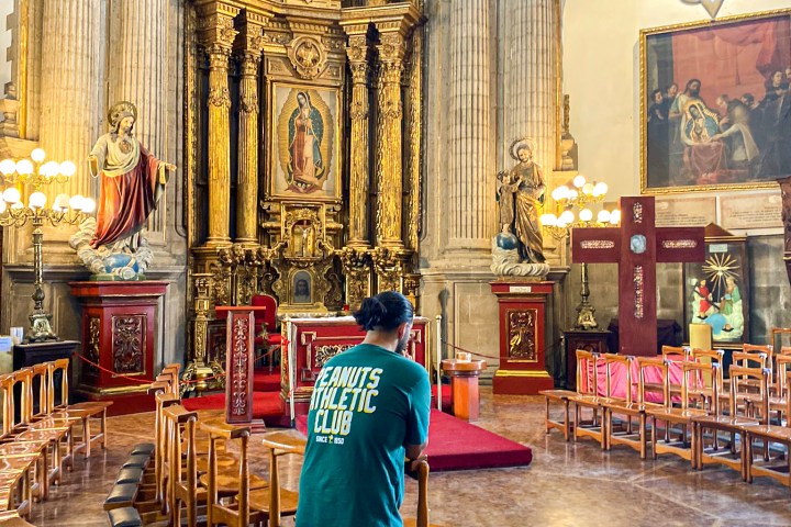 a person sitting in a chair in front of a building
