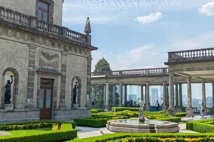 a large stone statue in front of a building