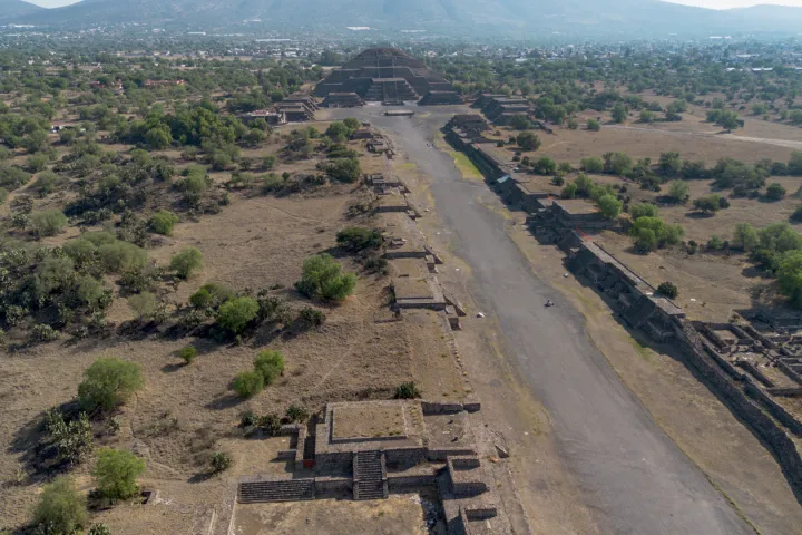 a dirt path next to a body of water