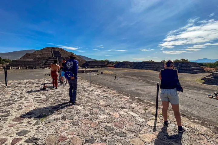 a group of people standing on top of a sandy beach