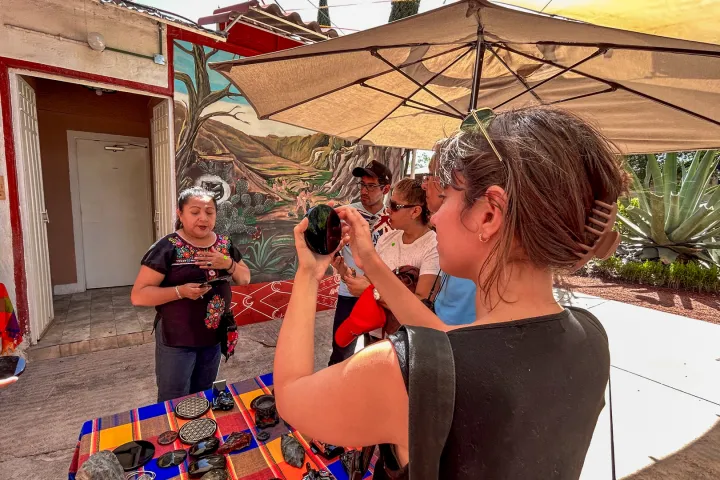a person standing in front of a building talking on a cell phone