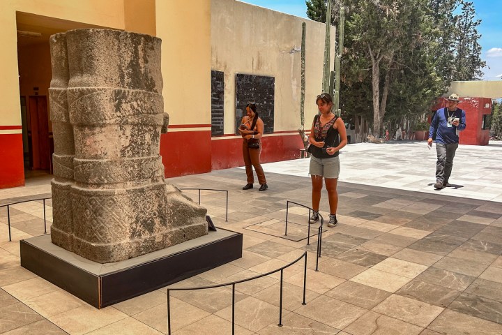 a person walking down a sidewalk next to a building