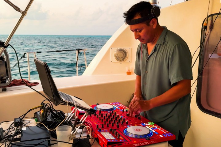 a man standing in front of a boat in the water
