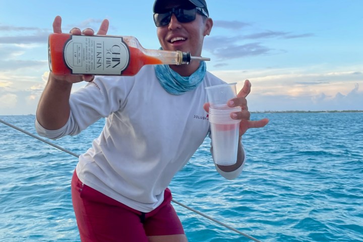 a woman standing next to a body of water