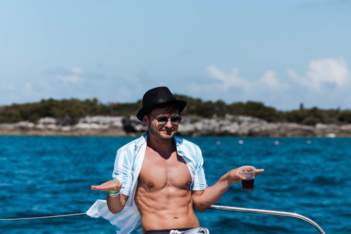 a person riding on the back of a boat in a body of water