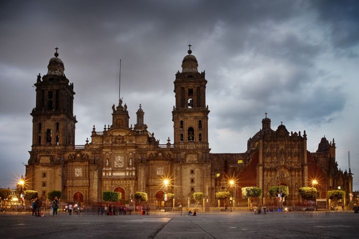 a view of a city at night in front of a church