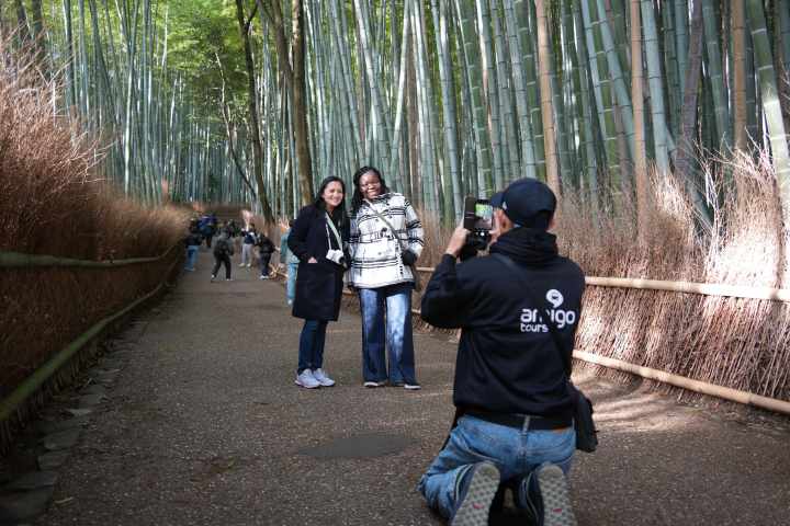 a group of people standing next to a tree